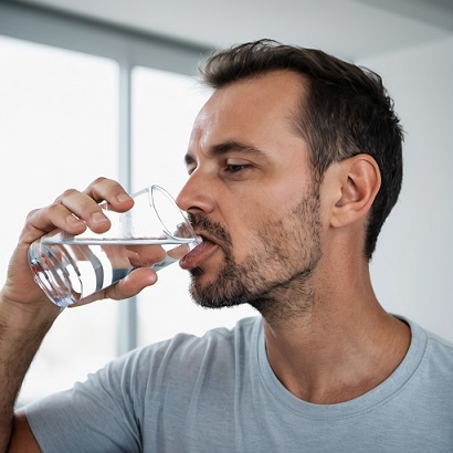 Person drinking water from glass
