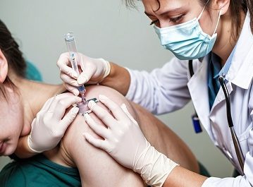 Person receiving a vaccine injection.